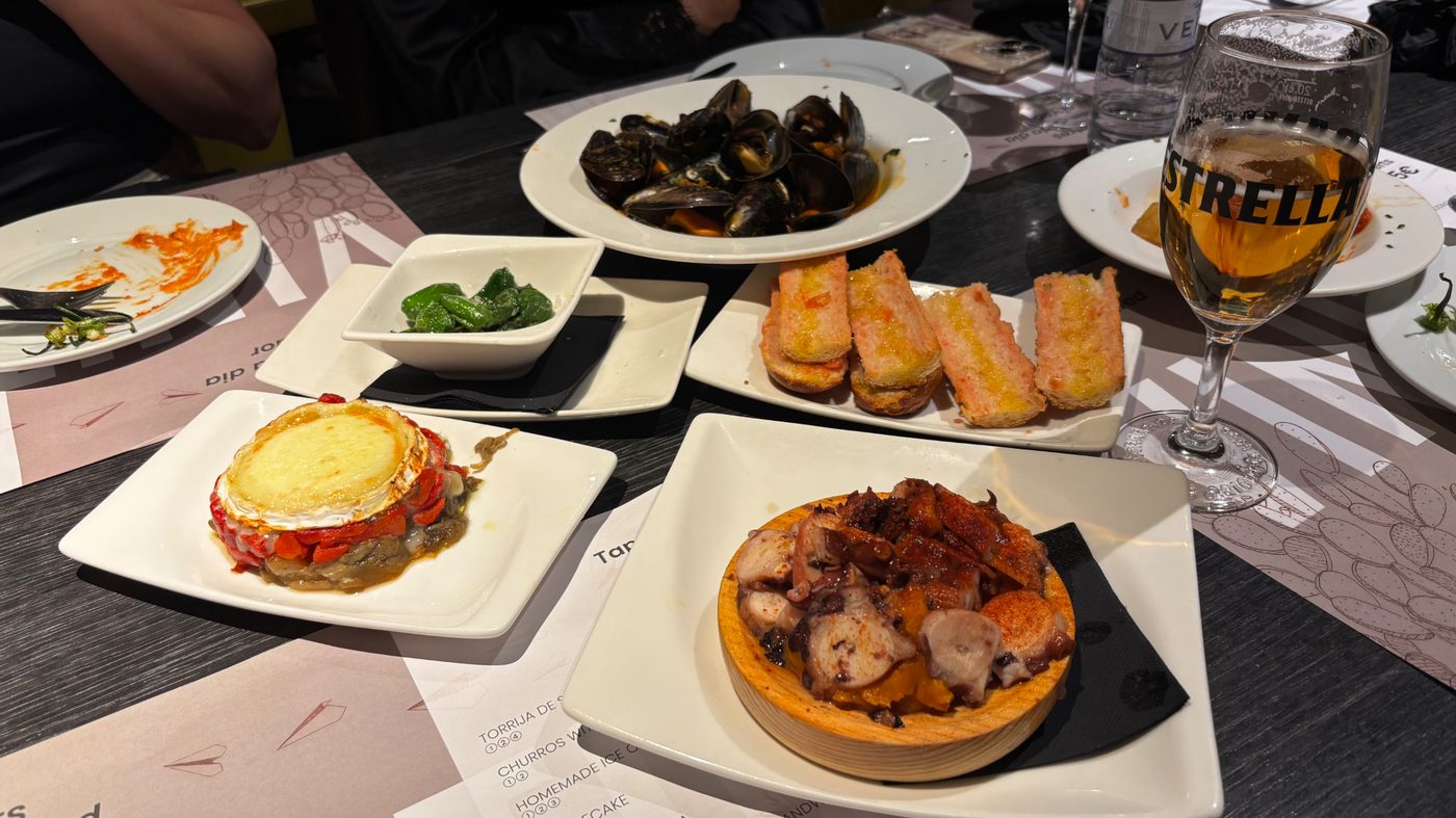 A tapas table with mussels, pimientos de Padrón and octopus